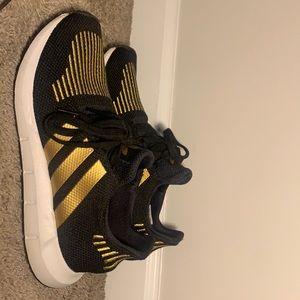Black and gold Adidas shoes